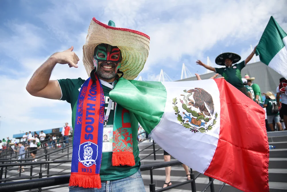 Mexikansk supporter som håller en mexikansk flagga
