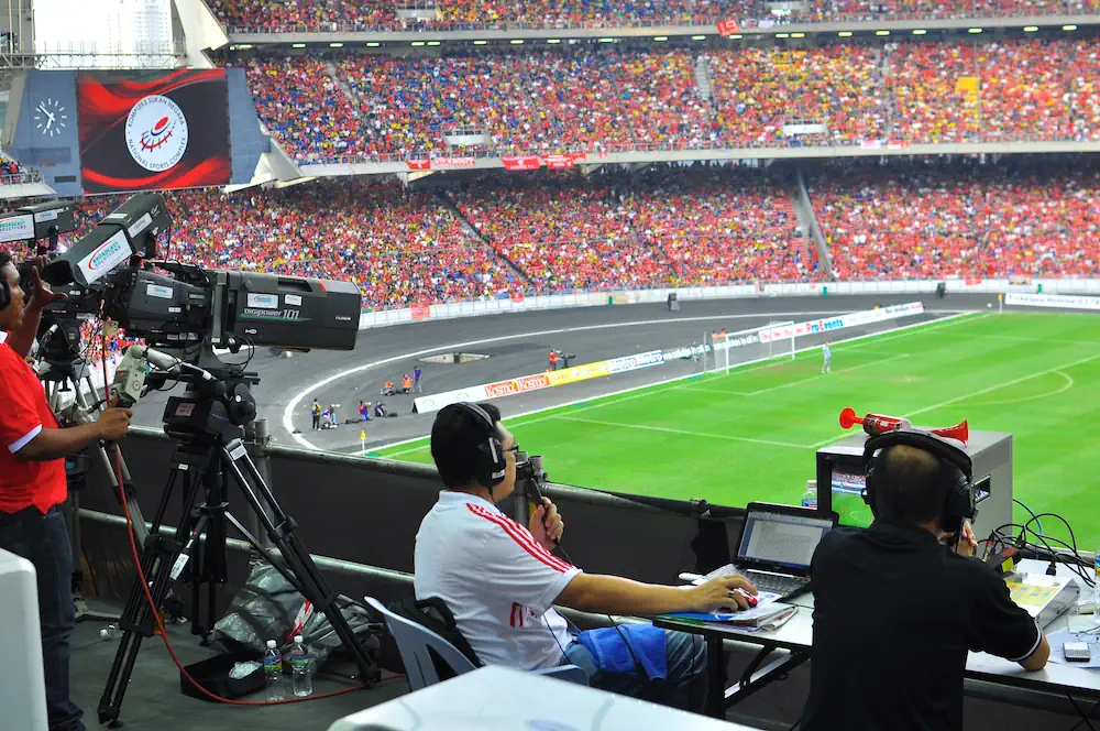 Kommentatorer på en fotbollsarena under en match